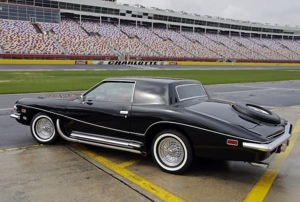 Dale Earnhardt Jr. takes Elvis Presley's 1973 Stutz Blackhawk III onto the track for a few laps after a news conference at Charlotte Motor Speedway in Concord, N.C., Tuesday, March 25, 2014. The car, the last car Presley drove before his death, will be the centerpiece of an exhibit during the AutoFair at the track from April 3-6. (AP Photo/Chuck Burton)