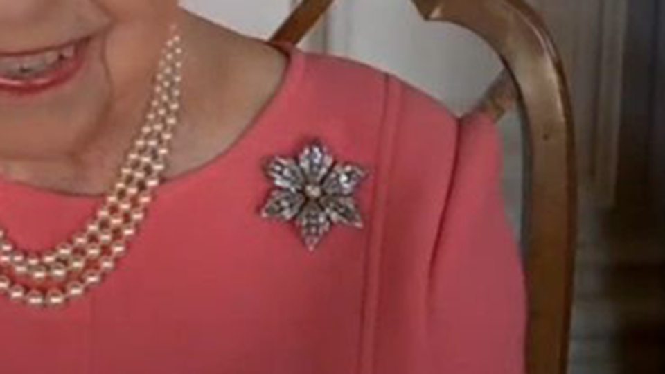 Close up of engagement brooch worn by queen Elizabeth in a nod to engagement to Prince Philip