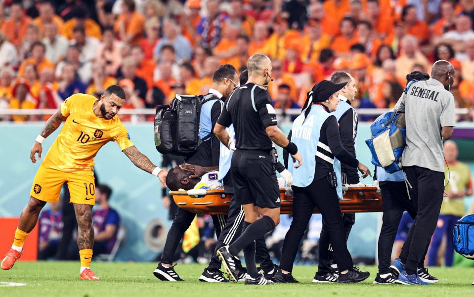 Cheikhou Kouyate (8) of Senegal being carried after receiving medical treatment due to injuries during FIFA World Cup Qatar 2022 Group A match between Senegal and Netherlands - Nottingham Forest in furious row with Senegal - Anadolu Agency/Getty Images