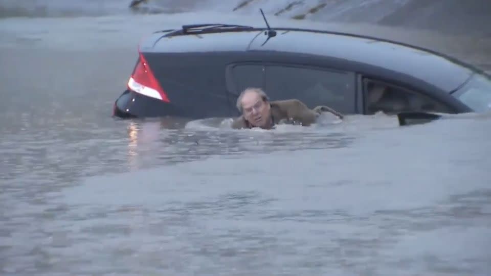 Eventually he begins to swim, leaving his sinking car behind. Photo: ABC13