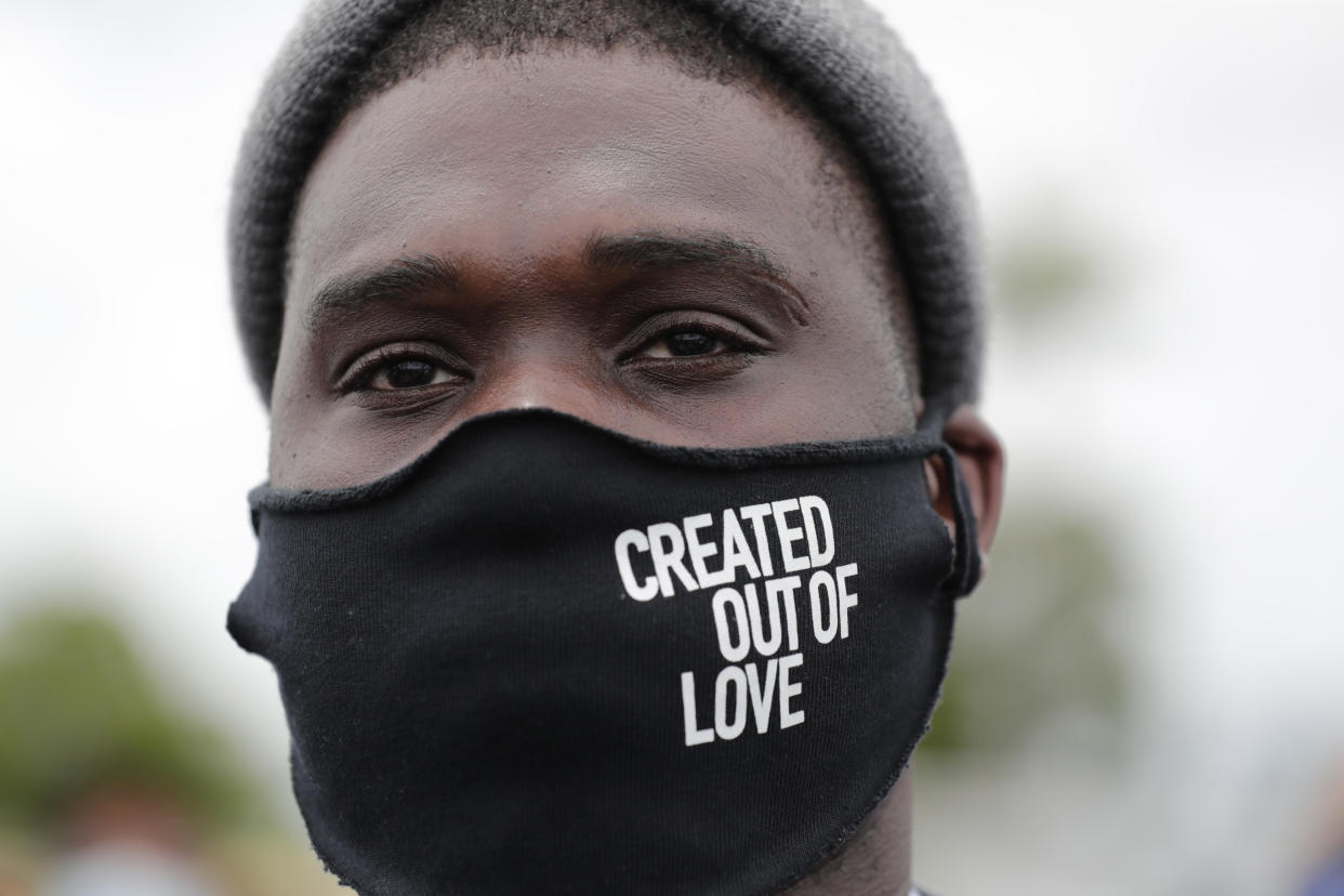 Mario Aristil wears a protective face mask before a police escorted funeral procession  Wednesday, June 3, 2020, in Hallandale Beach, Fla., organized by the COOL Church to symbolize a day of mourning for those lives lost due to systemic racism. The protest is in conjunction with protests held throughout the country over the death of George Floyd, a black man who died after being restrained by Minneapolis police officers on May 25. (AP Photo/Lynne Sladky)