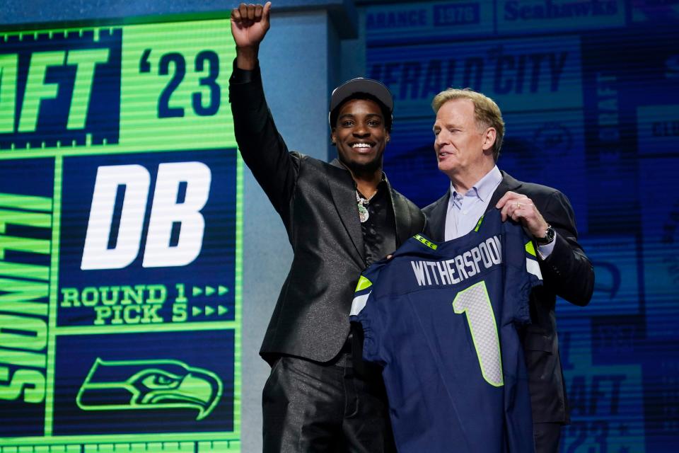 Former Pine Forest High defensive back Devon Witherspoon, left, stands with NFL Commissioner Roger Goodell after being chosen by the Seattle Seahawks with the fifth overall pick during the first round of the NFL football draft, Thursday, April 27, 2023, in Kansas City, Mo.