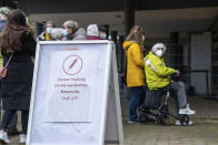 People line up for vaccination against the COVID-19 disease in Osnabueck, Germany, Saturday, Nov. 13, 2021. Germany has struggled to bring new momentum to its vaccination campaign lately, with a bit over two-thirds of the population fully vaccinated, and has balked so far at ordering vaccine mandates for any professional group. (Lino Mirgeler/dpa via AP)