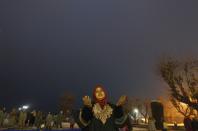 A Kashmiri Muslim woman prays during the festival of Eid-e-Milad-ul-Nabi at Hazratbal shrine on a cold winter morning in Srinagar January 14, 2014. Thousands of Kashmiri Muslims on Tuesday thronged to the shrine of Hazratbal, which houses a relic believed to be a hair from the beard of Prophet Mohammad, to celebrate Eid-e-Milad-ul-Nabi, the Prophet's birth anniversary. REUTERS/Danish Ismail (INDIAN-ADMINISTERED KASHMIR - Tags: RELIGION SOCIETY)