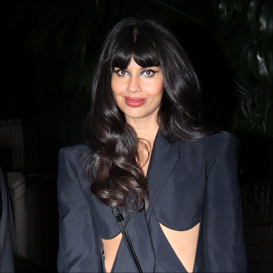  Jameela Jamil stunned in a cutout black pantsuit and Thom Browne handbag. 