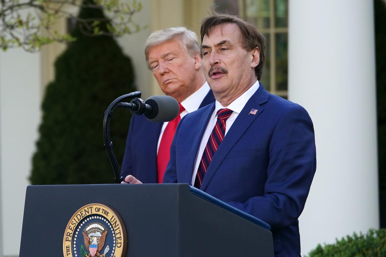 US President Donald Trump listens as Michael J. Lindell, CEO of MyPillow Inc., speaks during the daily briefing on the novel coronavirus, COVID-19, in the Rose Garden of the White House in Washington, DC, on March 30, 2020. (Mandel Ngan/AFP via Getty Images)