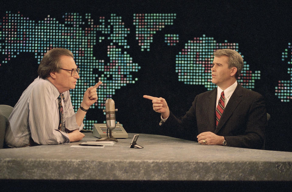 FILE - IN this Jan. 26, 1994 file photo, Oliver North talks to television show host Larry King prior to the start of CNN's 'Larry King Live' in Washington. King, who interviewed presidents, movie stars and ordinary Joes during a half-century in broadcasting, has died at age 87. Ora Media, the studio and network he co-founded, tweeted that King died Saturday, Jan. 23, 2021 morning at Cedars-Sinai Medical Center in Los Angeles. (AP Photo/Shayna Brennan, File)