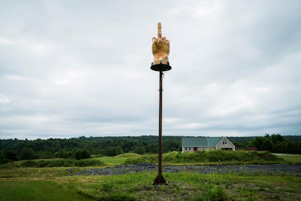 A 7-foot-tall middle finger sits atop a stand in front of the home of Ted Pelkey of Westford. The sculpture, made by wood carved Charlie O'Brien, was commissioned by Pelkey in protest of a long-standing zoning dispute with the town.  Robert Ritchie (Aka. Kid Rock) saw news reports about the sculpture and ordered one for himself.