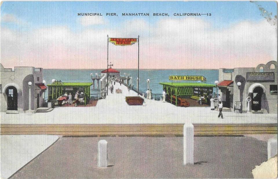 An old postcard shows a street-level view of the Manhattan Beach Pier