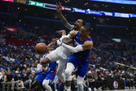 LA Clippers guard Russell Westbrook, right, fouls Dallas Mavericks forward P.J. Washington (25) during the first half of Game 1 of an NBA basketball first-round playoff series in Los Angeles, Sunday, April 21, 2024. (AP Photo/Ashley Landis)