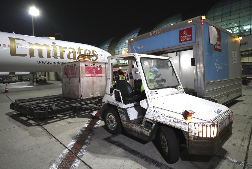 A Pfizer-BioNTech COVID-19 coronavirus vaccines shipment is offloaded from an Emirates Airlines Boing 777 that arrived from Brussels at Dubai International Airport in Dubai, United Arab Emirates, early Sunday, Feb. 21, 2021. As the coronavirus pandemic continues to clobber the aviation industry, Emirates Airlines, the Middle East’s biggest airline is seeking to play a vital role in the global vaccine delivery effort. (AP Photo/Kamran Jebreili)