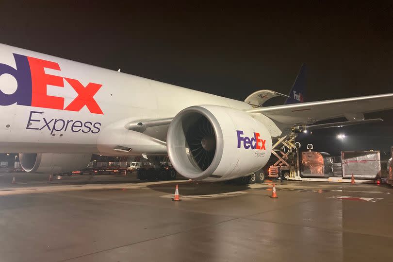 Crates of goods being unloaded from the 777 cargo plane at Stansted Airport