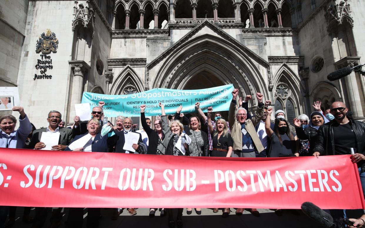 Former post office workers celebrating outside the Royal Courts of Justice, London, after their convictions were overturned by the Court of Appeal