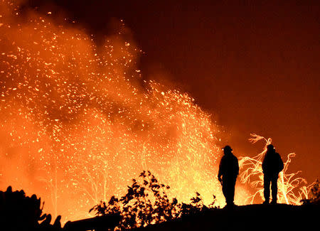 Firefighters keep watch on the Thomas wildfire in the hills and canyons outside Montecito, California, U.S., December 16, 2017. REUTERS/Gene Blevins