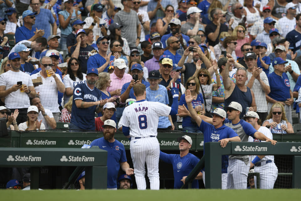 Chicago Cubs' Ian Happ (8) celebrates with manager Craig Counsell, center right, at the dugout after hitting a three-run home run during the fourth inning of a baseball game against the Philadelphia Phillies, Thursday, July 4, 2024, in Chicago. (AP Photo/Paul Beaty)