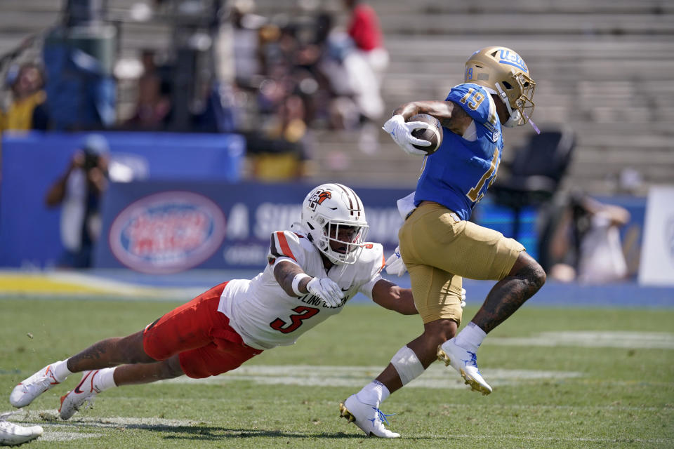 UCLA wide receiver Kazmeir Allen, right, runs the ball as Bowling Green safety Chris Bacon attempts a tackle during the second half of an NCAA college football game Saturday, Sept. 3, 2022, in Pasadena, Calif. (AP Photo/Mark J. Terrill)