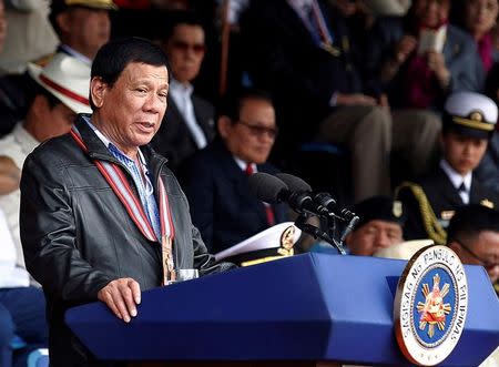 Philippine President Rodrigo Duterte delivers a speech during the Philippine Military Academy (PMA) alumni homecoming in Fort Del Pilar, Baguio city, north of Manila, Philippines February 18, 2017. REUTERS/Harley Palangchao