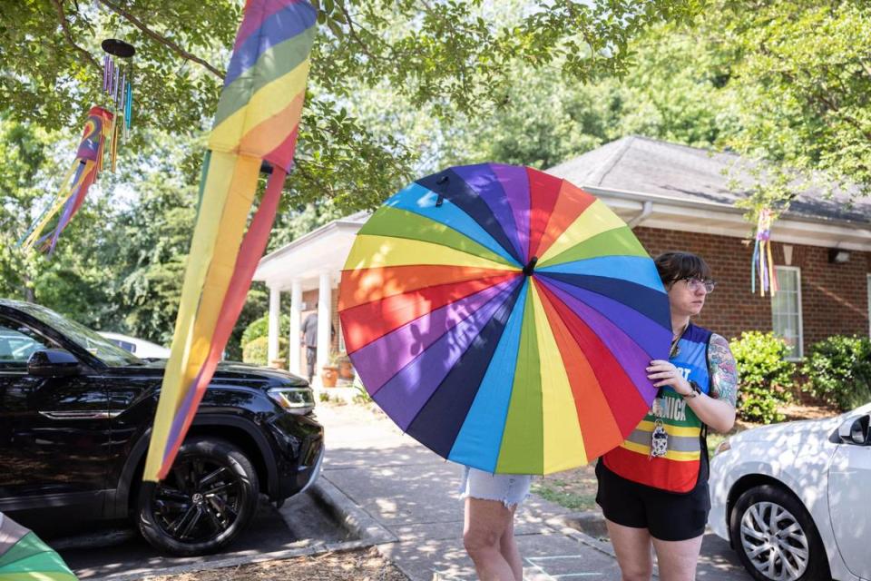 Shane Becker a clinic escort for Charlotte for Choice, shields a fellow volunteer while working on a Saturday in June outside A Preferred Women’s Health Center in Charlotte.