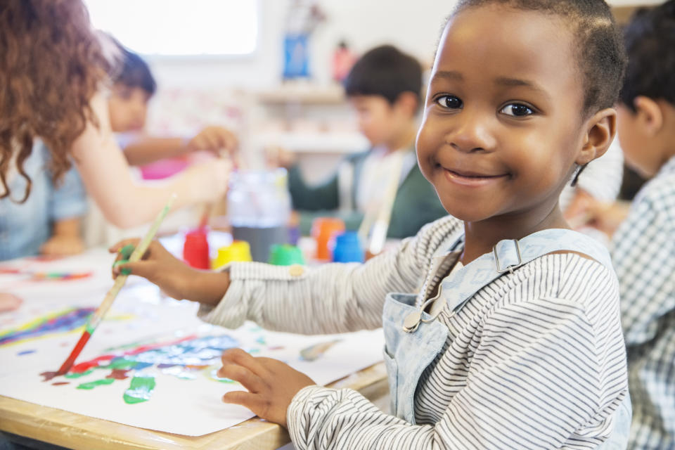 young child at nursery smiling at the camera