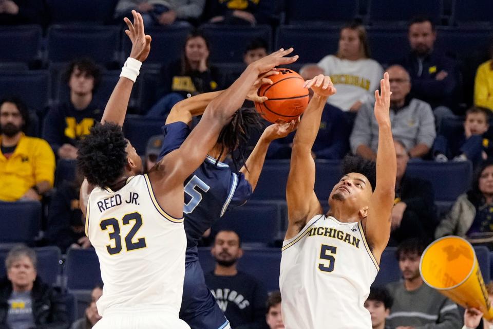 Michigan forwards Tarris Reed Jr. (32) and Terrance Williams II (5) block a layup by Northwood guard Jordan Jackson (5) during the first half at Crisler Center in Ann Arbor on Friday, Nov. 3, 2023.