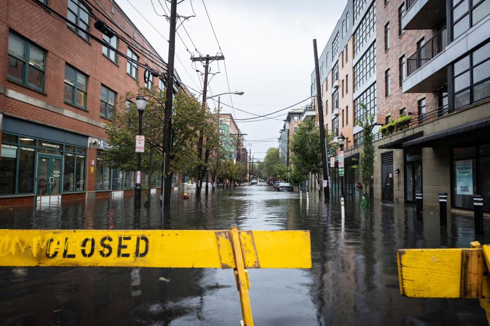 A flooded street due to heavy rain is blocked in Hoboken, N.J., on Friday, Sept. 29, 2023.