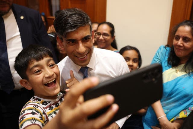 Rishi Sunak and a boy take a selfie