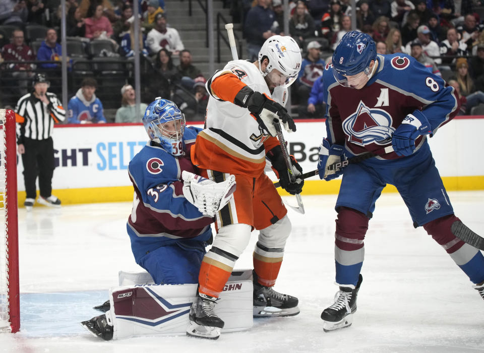 Colorado Avalanche goaltender Pavel Francouz, left, makes a glove save as Anaheim Ducks center Adam Henrique is cleared by Avalanche defenseman Cale Makar during the second period of an NHL hockey game Thursday, Jan. 26, 2023, in Denver. (AP Photo/David Zalubowski)