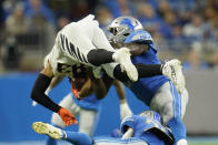 Cincinnati Bengals wide receiver Tyler Boyd (83) is tackled by Detroit Lions outside linebacker Charles Harris during the first half of an NFL football game, Sunday, Oct. 17, 2021, in Detroit. (AP Photo/Paul Sancya)