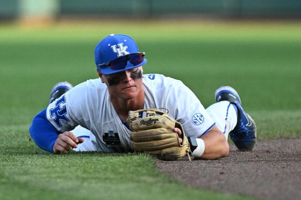 Kentucky shortstop Grant Smith dives for a ground ball against Texas A&M during the fifth inning at Charles Schwab Field in Omaha, Nebraska.