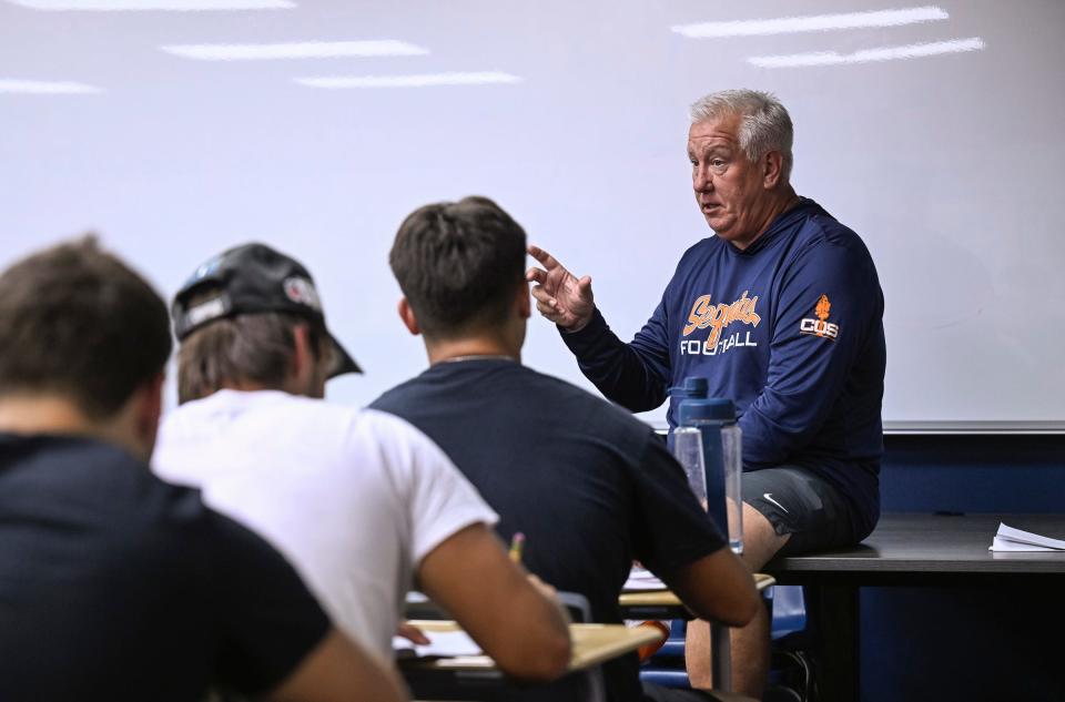 Donovan McJunkin, College of the Sequoias assistant head football coach and tight ends coach, talks with players after practice on Monday, September 18, 2023.