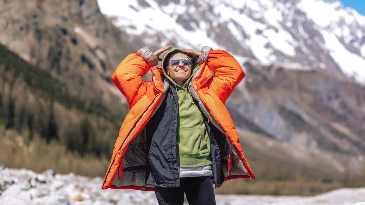  Woman wearing an outdoor jacket in the mountains. 