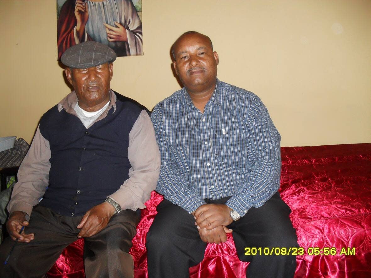 Mulugeta Tedla, right, sits with his father, Atakhelti Tedla, in this photo from 2010. (Submitted by MulugetaTedla - image credit)