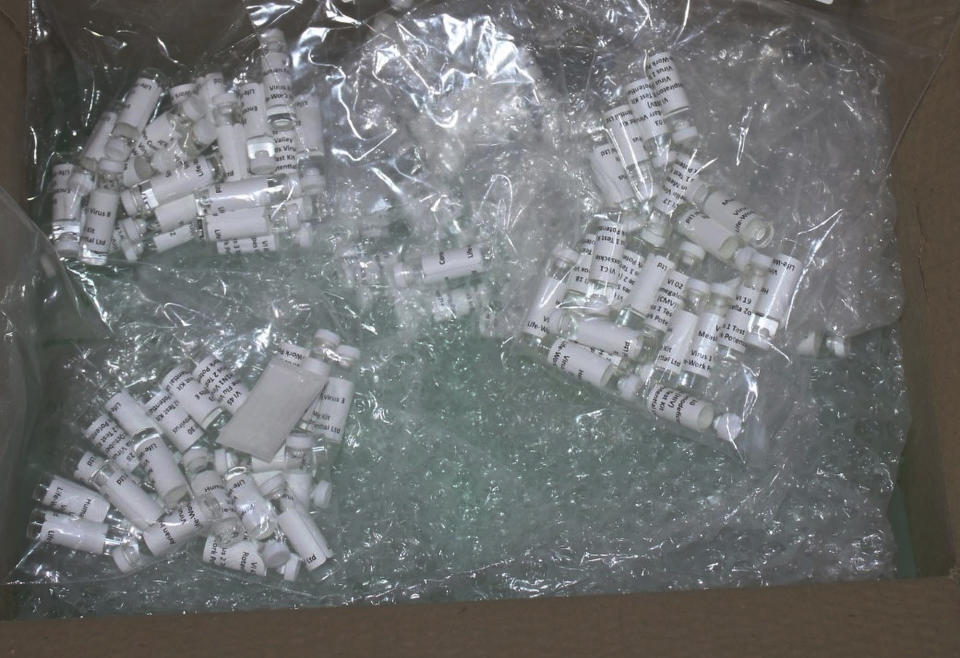 In this Thursday, March 12, 2020, photo released by the U.S. Customs and Border Protection (CBP), shows a package containing suspected counterfeit COVID-19 test kits arriving from the United Kingdom. CBP officers discovered six plastic bags containing various vials, while conducting an enforcement examination of a parcel manifested as "Purified Water Vials" with a declared value of $196.81. A complete examination of the shipment, led to the finding of vials filled with a white liquid and labeled "Corona Virus 2019nconv (COVID-19)" and "Virus1 Test Kit". The shipment was turned over to the U.S. Food and Drug Administration (FDA) for analysis. (U.S. Customs and Border Protection via AP)