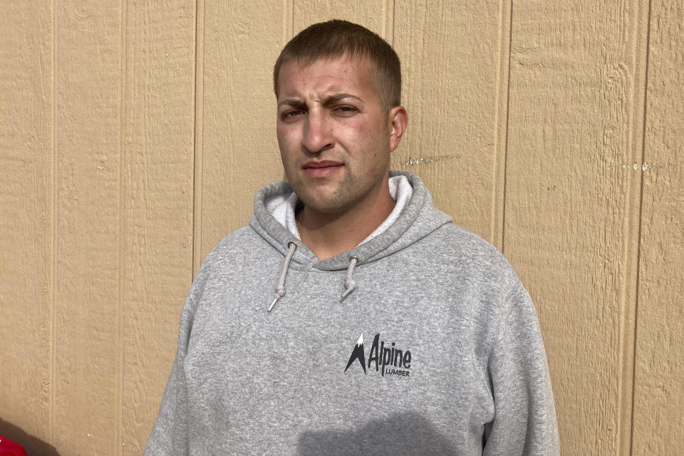 Jerecho Loveall, 30, stands for a portrait his home Sunday, Dec. 4, 2022, in Colorado Springs, Colo. Loveall, who is recovering from a wound to the leg from one of the high-powered rounds in the Nov. 19 mass shooting at Club Q, says, “If they would have taken this more seriously and done their job, the lives we lost, the injuries we sustained and the trauma this community has faced would not have happened.” (AP Photo/Jim Mustian)