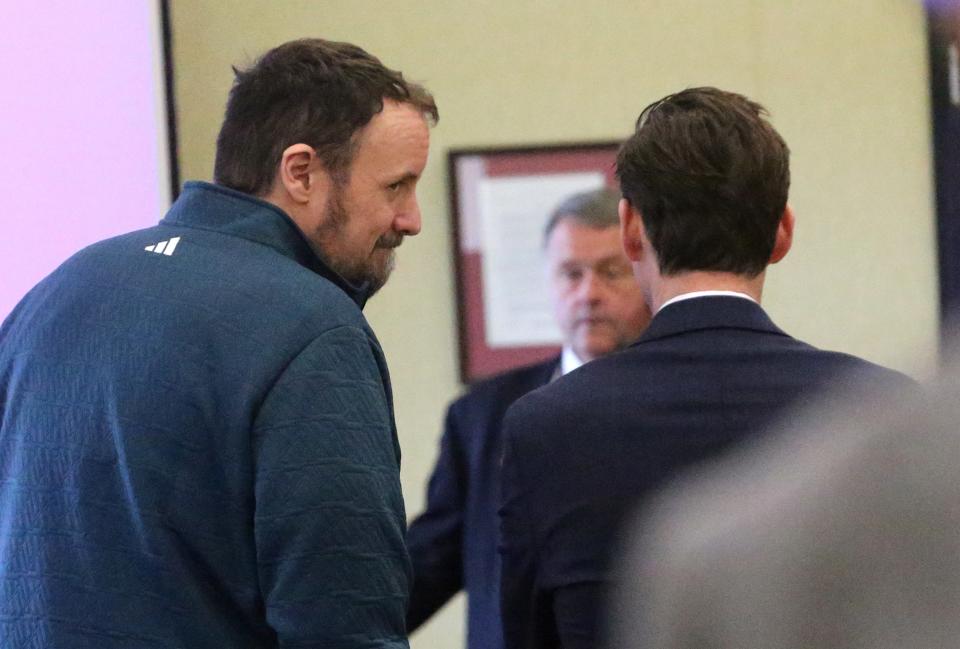 Double-murder defendant Timothy Verrill, left, speaks with his attorney Matthew McNicoll in Strafford Superior Court in Dover Friday, March 29, 2024.