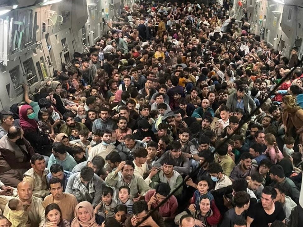 Cropped version of a photo provided courtesy of Defense One shows the inside of Reach 871, a U.S. Air Force C-17 cargo plane flown from Kabul to Qatar on Aug. 15, 2021. A defense official told Defense One that approximately 640 Afghan civilians were on board the flight.  Mandatory credit:  courtesy of Defense One