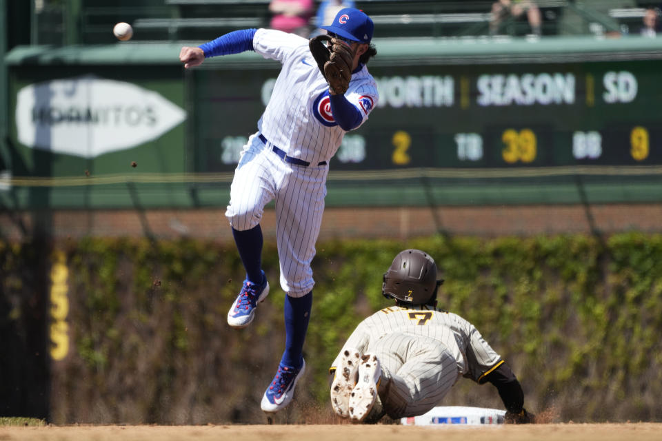 San Diego Padres' Ha-Seong Kim, right, of South Korea, steals second base as Chicago Cubs shortstop Dansby Swanson waits for the ball during the third inning of a baseball game in Chicago, Thursday, April 27, 2023. (AP Photo/Nam Y. Huh)