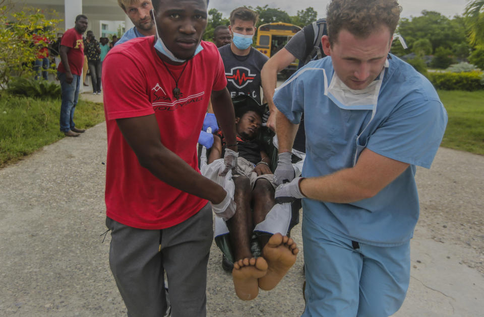 A man injured by the recent 7.2 magnitude earthquake is transferred to the Ofatma hospital in Les Cayes, Haiti, Thursday, Aug. 19, 2021. (AP Photo/Joseph Odelyn)