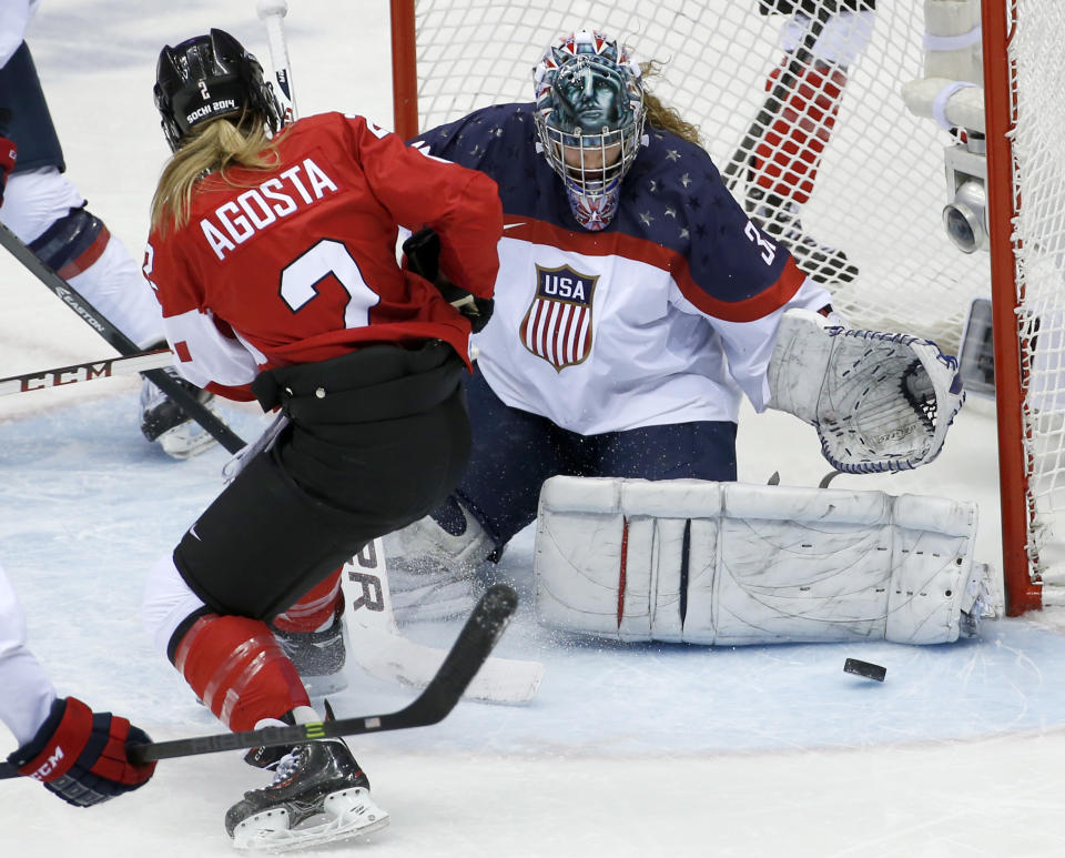 USA goalkeeper Jessie Vetter (31) blocks Meghan Agosta-Marciano of Canada (2) shot on the goal during the second period of the women's gold medal ice hockey game at the 2014 Winter Olympics, Thursday, Feb. 20, 2014, in Sochi, Russia. (AP Photo/Petr David Josek)