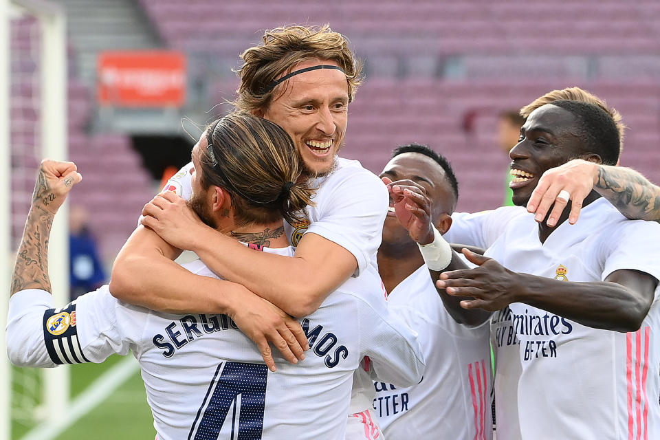 Real Madrid players celebrate a late goal by Luka Modric (middle) in Saturday's 3-1 win over Barcelona. (Lluis Gene/Getty Images)