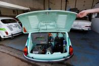 A worker opens the hatch of converted supermini car Zastava 750, which has its combustion engine replaced with an electric one by BB Classic Cars, in Skopje