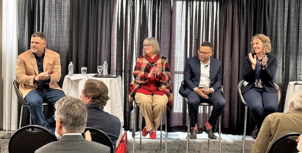 Cook Group President Pete Yonkman, left, and Bloomington mayoral candidates Susan Sandberg, Don Griffin Jr. and Kerry Thomson applaud before a candidate forum on April 19, 2023, at the Monroe County Convention Center.