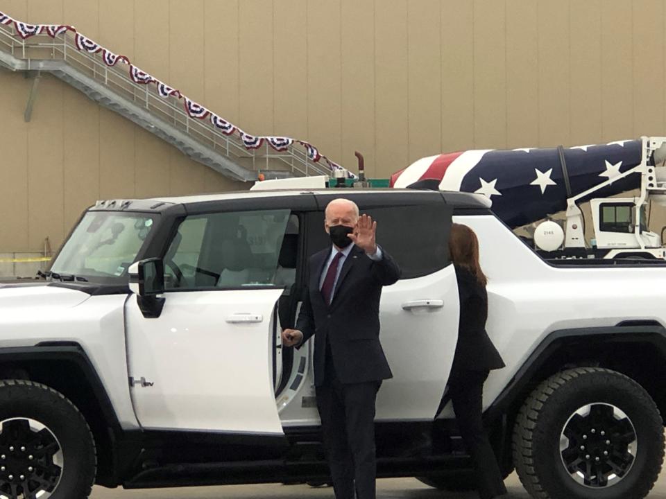 President Joe Biden waves to a crowd gathered at General Motors Factory ZERO in Detroit and Hamtramck as he and GM CEO Mary Barra get in a 2022 GMC Hummer EV to do a test drive on Nov. 17, 2021.