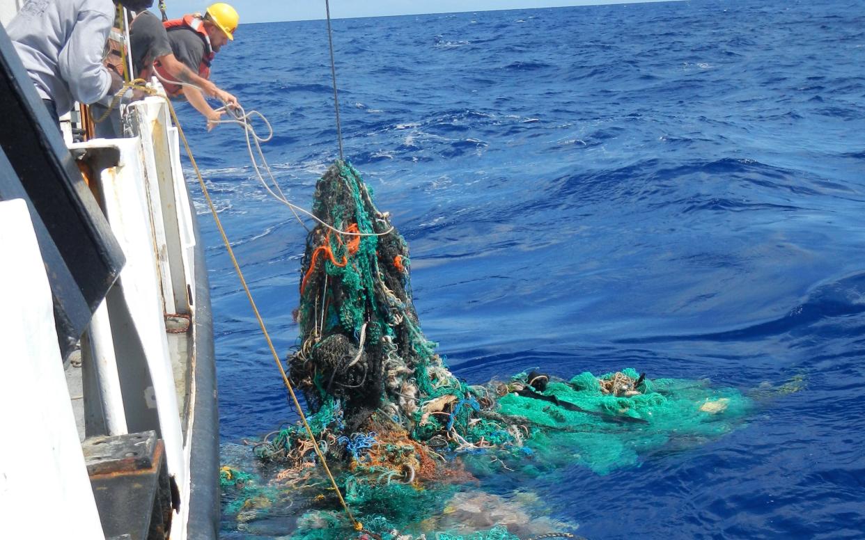 Researchers pulling in discarded fishing nets  - The Ocean Cleanup Foundation 