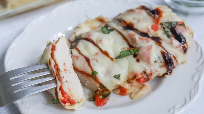 Bruschetta chicken on plate with fork