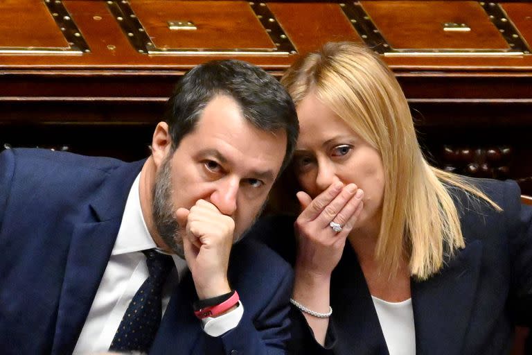 TOPSHOT - Italy’s new Prime Minister Giorgia Meloni talks with Deputy Prime Minister and Minister of Infrastructure, Matteo Salvini after her first address to parliament, ahead of a confidence vote at Montecitirio palace in Rome on October 25, 2022. - Meloni said that Italy would "continue to be a reliable partner of NATO in supporting Ukraine", amid concerns over the pro-Russian stance of her coalition partners. (Photo by Andreas SOLARO / AFP)