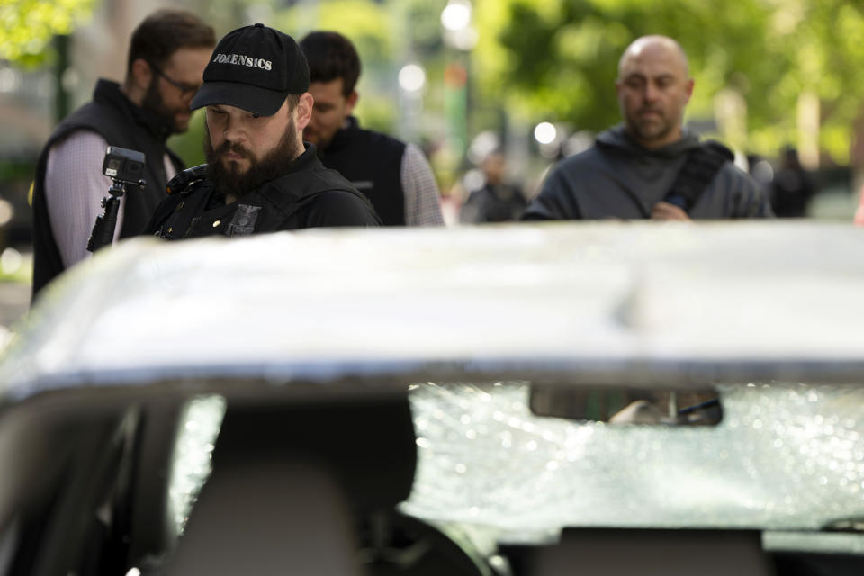 A car that attempted to drive through a crowd of pro-Palestinian protesters on the Portland State University campus is seen parked and damaged on a campus walkway on Thursday, May 2, 2024, in Portland, Ore. After the driver fled on foot the protesters damaged the car. (AP Photo/Jenny Kane)