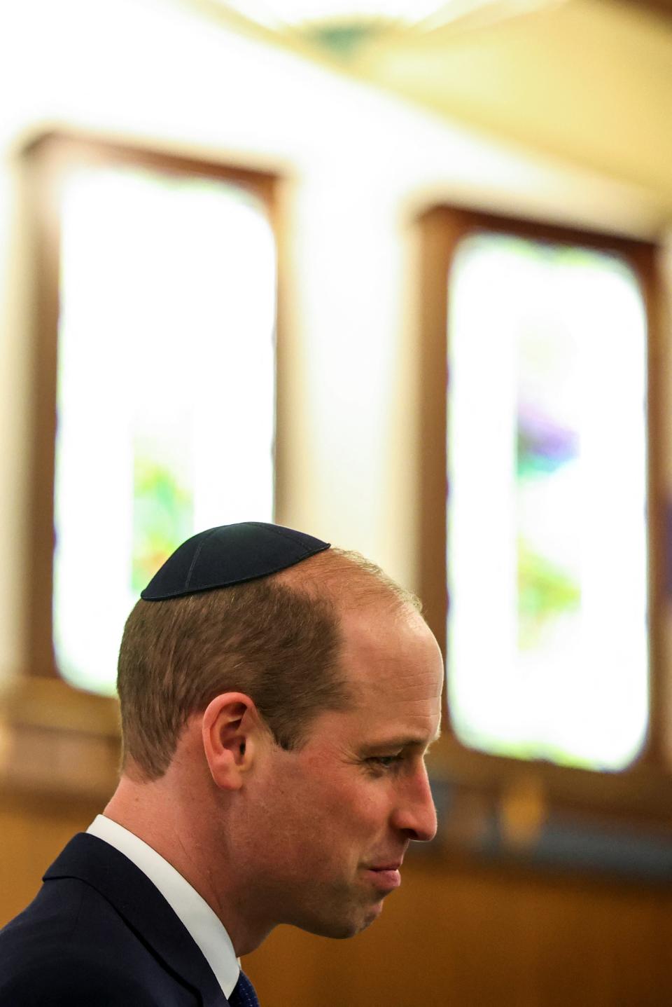 Prince William wears a kippah as he visits the Western Marble Arch Synagogue, in London (REUTERS)