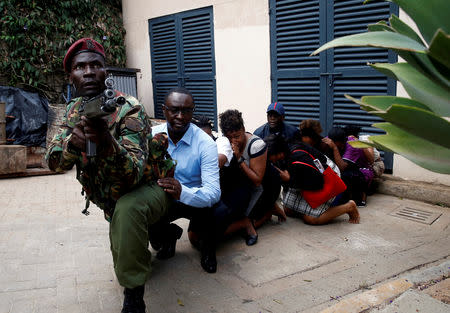 FILE PHOTO: People are evacuated by a member of the security forces at the scene where explosions and gunshots were heard at the Dusit hotel compound in Nairobi, Kenya January 15, 2019. REUTERS/Baz Ratner/File Photo