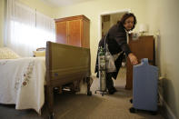 In this photo taken Thursday, Dec. 5, 2019, administrator Irais Lopez-Ortega reaches for electric breathing equipment that would not work in the recent power shutoffs at the Cedars Care Home in Calistoga, Calif. Even before widespread blackouts hit California this fall, the utility that triggered them showed signs it wasn’t fully prepared. An Associated Press review reveals persistent problems during four smaller shutoffs that Pacific Gas & Electric did starting last year so power lines downed by strong winds wouldn’t spark wildfires. (AP Photo/Eric Risberg)